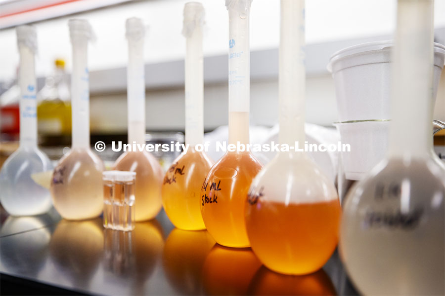Flasks of liquids for future labs await their turn in the spotlight. As a result of the Corona virus, Faculty are recording Chemistry labs in Hamilton Hall to prepare for the start of remote learning. March 24, 2020. Photo by Craig Chandler / University Communication.