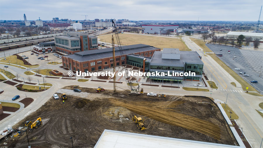 Excavators are busy moving piles of dirt where a new Hotel will be built on Nebraska Innovation Campus (open space center of the photo). March 24, 2020 Photo by Craig Chandler / University Communication.
