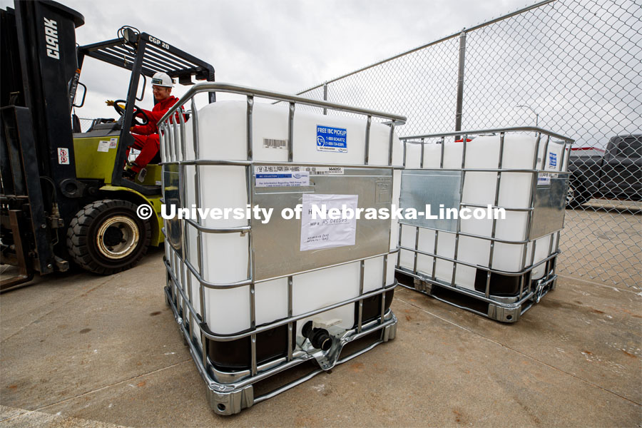 Russell Parde drives a forklift after lowering a container of hand sanitizer after it was emptied into smaller jugs. Hand sanitizer is being made at Nebraska Innovation Campus thanks to a collaboration between the Food Innovation Center and the Nebraska Ethanol Board. April 6, 2020. Photo by Craig Chandler / University Communication.