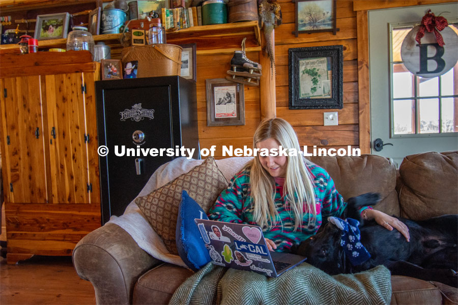Katie Bresnahan does remote learning from her home in Hordville, NE, despite distractions from her dog, Wrex. As a result of the Corona virus, Katie is studying from home. April 9, 2020. Photo by Katie Bresnahan for University Communication.