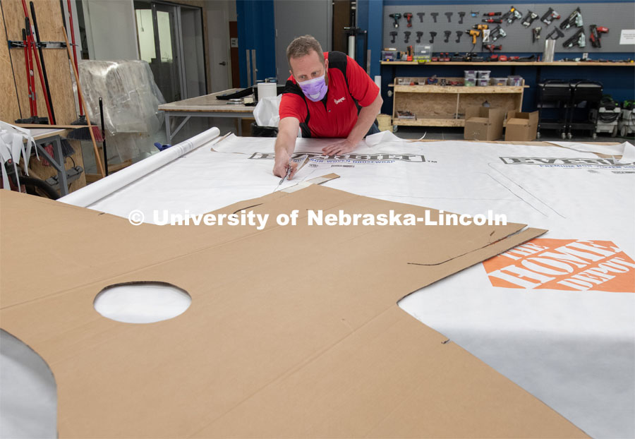 Jerry Reif, shop manager at Nebraska Innovation Studio, cuts hospital gowns from Tyvec material house wrap. The gowns are being assembled for hospitals in Nebraska in response to COVID-19. April 9, 2020. Photo by Gregory Nathan / University Communication.