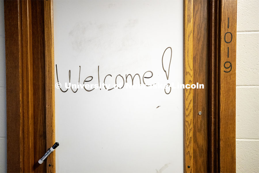 “Welcome!” is written on a marker board outside a room in Harper Hall. To enable first responders and medical personnel to self-isolate while still working, Harper Residence Hall will be used to house them. Resident Hall Custodians are being trained to use PPE and safely clean the residence hall. April 10, 2020. Photo by Craig Chandler / University Communication.