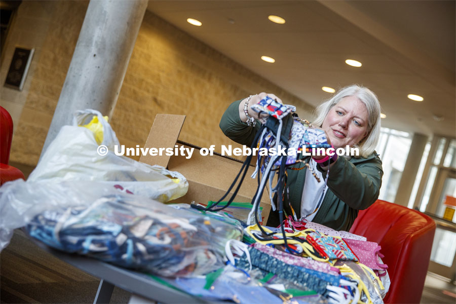 Veronica Riepe, director of student involvement, counts donated masks at University Suites before they're distributed to the nearly 1,000 university employees who continue to work on campus. She is coordinating donations for every housing worker. April 13, 2020 Photo by Craig Chandler / University Communication.