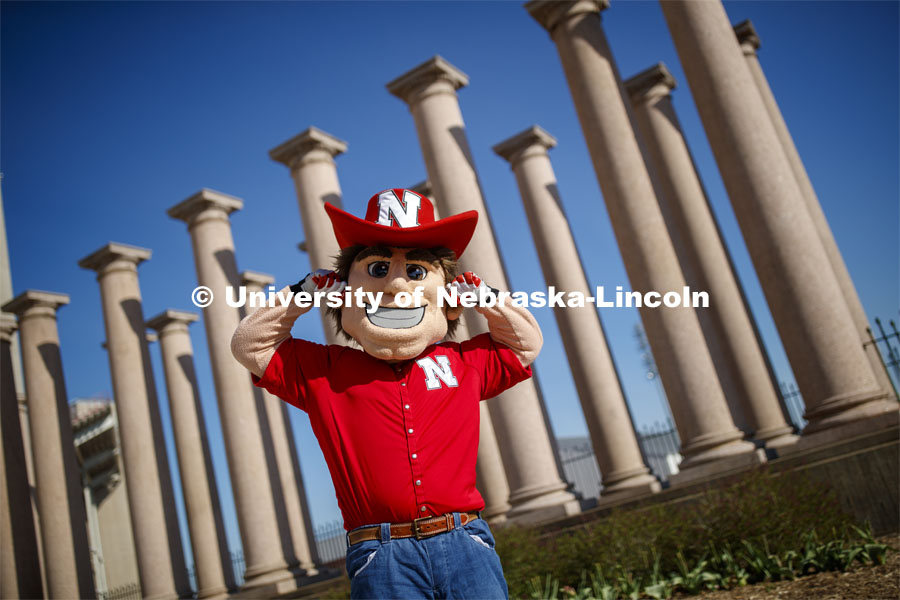 Herbie Husker in front of the columns by Memorial Stadium. On campus. April 30, 2020. Photo by Craig Chandler / University Communication.
