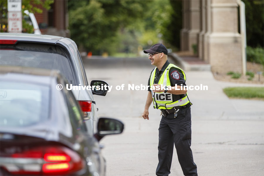 UNL Police direct the huge traffic flow for people coming for the free flat of flowers left from the Horticulture Club Plant Sale. May 21, 2020. Photo by Craig Chandler / University Communication.