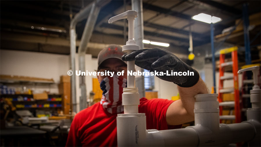 This is the thread adaptor made in a 3-D printer at Nebraska Innovation Studio that makes it possible to fit the hand pump to the PVC pipe sanitizing station. Jim Jackson, associate vice chancellor of University Operations, put a team together to solve the problem of efficiently distributing hand sanitizer across campus. They invented the large-capacity, free-standing dispenser station. June 3, 2020 Photo by Gregory Nathan / University Communication.