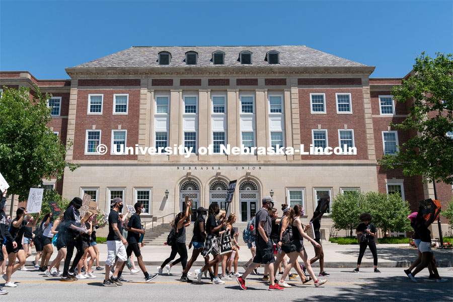 Protestors walk past the south entrance of the Nebraska Union during their march to the Nebraska State Capitol on Saturday, June 13th, 2020, in Lincoln, Nebraska. Black Lives Matter Protest. Photo by Jordan Opp for University Communication.