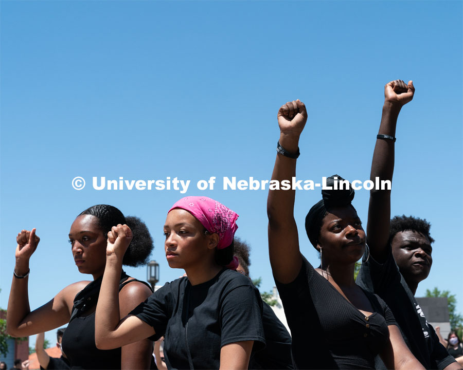 Protestors raise their right arms in the air during a moment of silence outside of Andersen Hall on Saturday, June 13th, 2020, in Lincoln, Black Lives Matter Protest. Nebraska. Photo by Jordan Opp for University Communication.