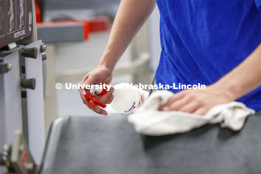 A student disinfects a weight station following his workout. First day of Campus Recreation re-opening after being shut down due to COVID-19 concerns. June 15, 2020. Photo by Craig Chandler / University Communication.