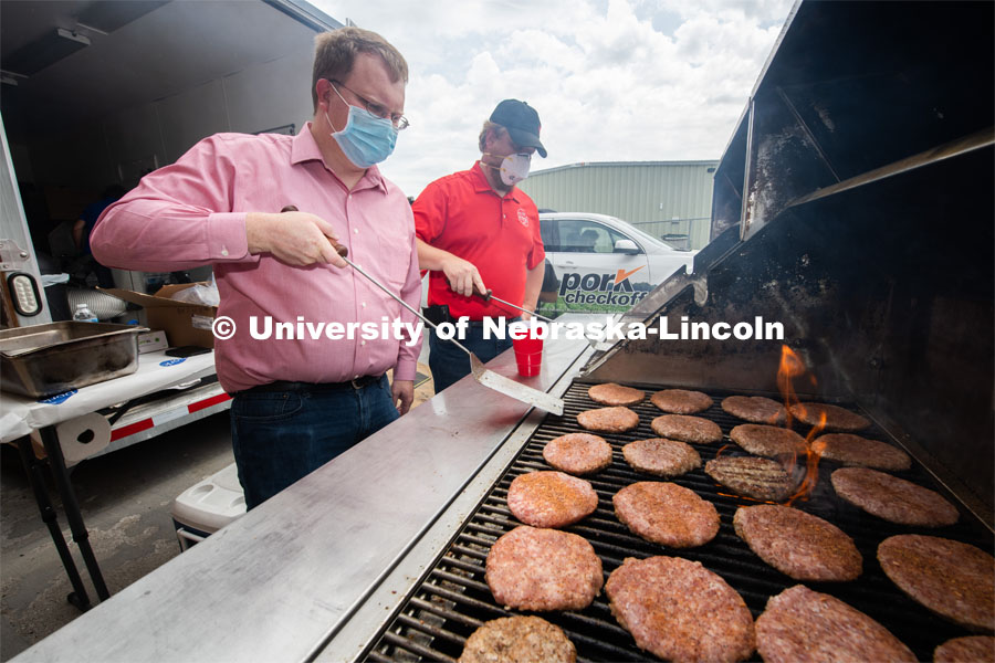 Gary Sullivan (left), associate professor, and Benny Mote (right), assistant professor in Animal Science grill up pork burgers. The pork, donated by pig farmer and University of Nebraska–Lincoln animal science alumnus, Bill Luckey, was the result of generosity, ingenuity, collaboration and a spirit of Nebraskans helping Nebraskans among the state’s pork producers, the Food Bank of Lincoln and the University of Nebraska–Lincoln. June 18, 2020. Photo by Gregory Nathan / University Communication.