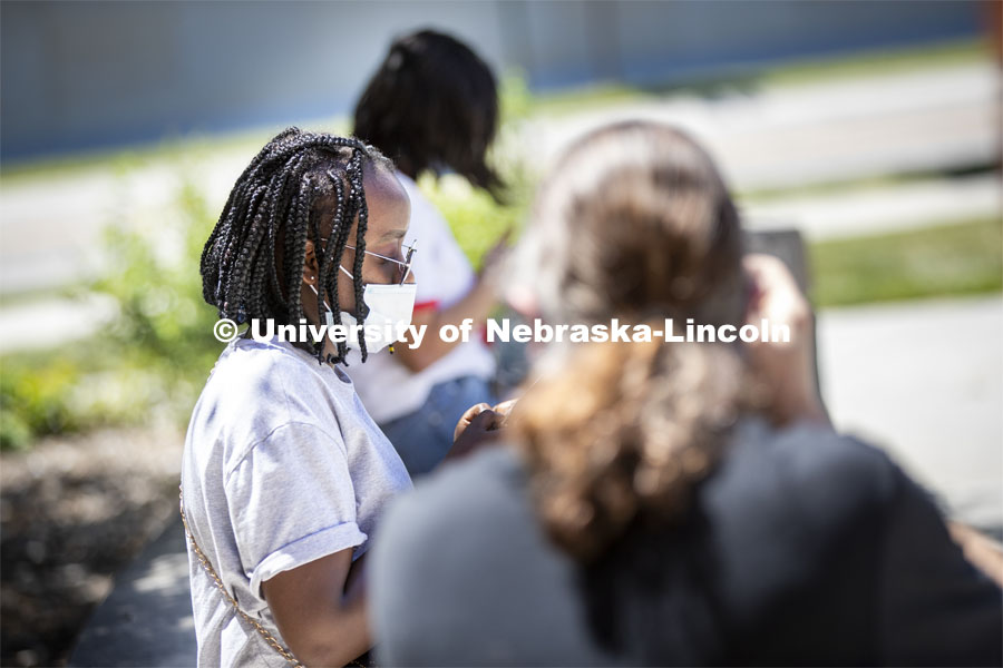 Sandhya Karki wears a mask while hanging out with friends. Photo shoot of students wearing masks and practicing social distancing. June 24, 2020. Photo by Craig Chandler / University Communication.