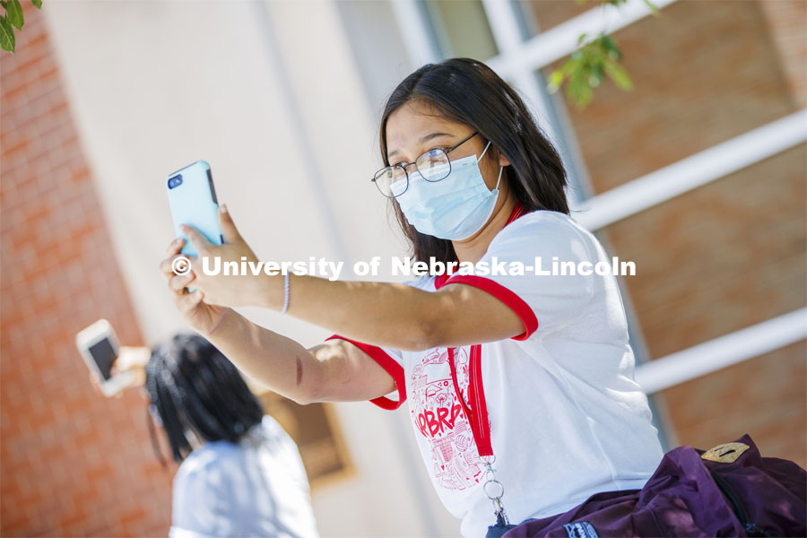 Sandhya Karki takes a selfie of herself wearing a mask. Photo shoot of students wearing masks and practicing social distancing. June 24, 2020. Photo by Craig Chandler / University Communication.