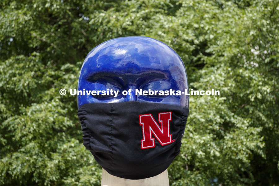 Untitled by Jun Kaneko in the Sheldon Sculpture Garden wearing a photoshopped mask. The sculpture is one of many UNL campus sculptures wearing masks. Mask wearing statues on campusJune 30, 2020. Photo by Craig Chandler / University Communication.