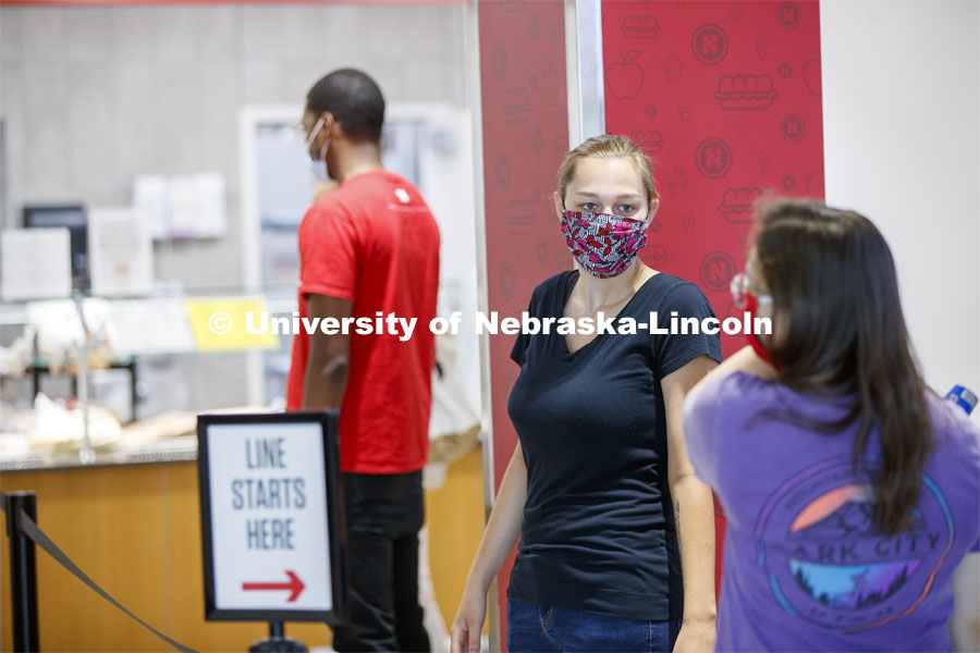 Students waiting in line at the Willa Cather Dining Center. Photo shoot of students wearing masks and practicing social distancing in dining services in Willa Cather Dining Center. July 1, 2020. Photo by Craig Chandler / University Communication.