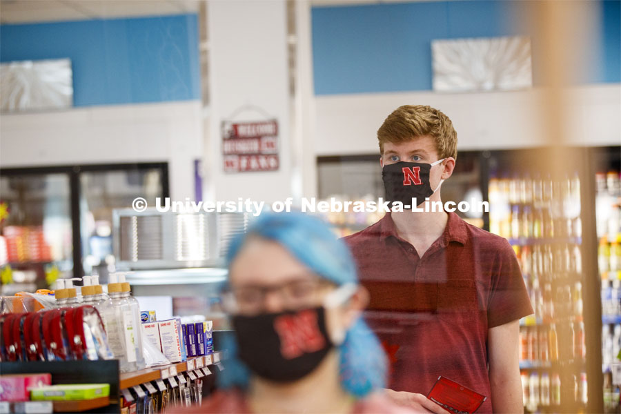 Students shopping in the convenience store. Photo shoot of students wearing masks and practicing social distancing in dining services in Willa Cather Dining Center. July 1, 2020. Photo by Craig Chandler / University Communication.