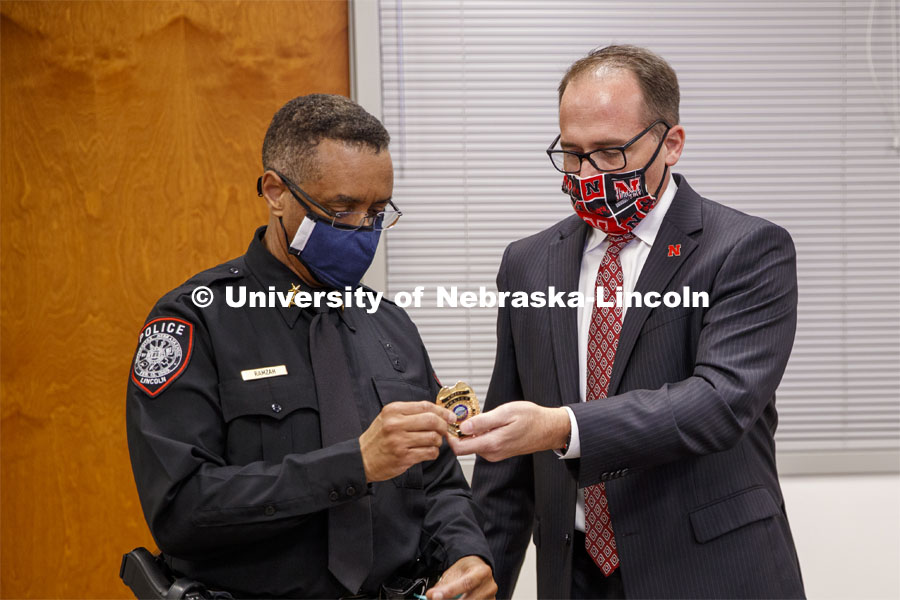 William Nunez, Vice Chancellor for Business and Finance, presents the police chief badge to Chief Hassan Ramzah. Ramzah had his badge presented to him today in a virtual ceremony from the police station. July 17, 2020. Photo by Craig Chandler / University Communication.