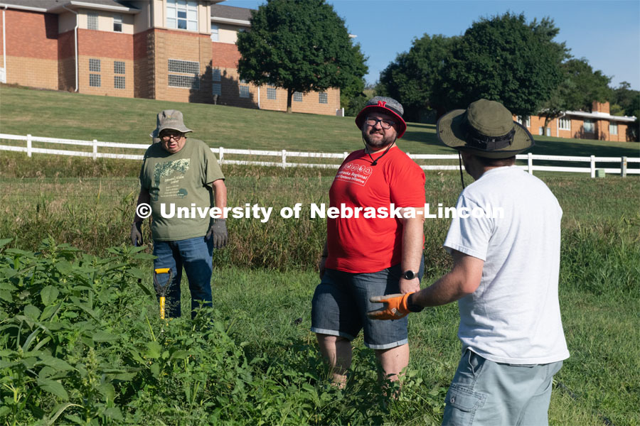 Extension Educator, John porter (in red), is part of the Urban Agriculture Program Coordinator. Master Gardeners work the garden. Cooper Farm in Omaha, Nebraska. July 22, 2020. Photo by Gregory Nathan / University Communication.