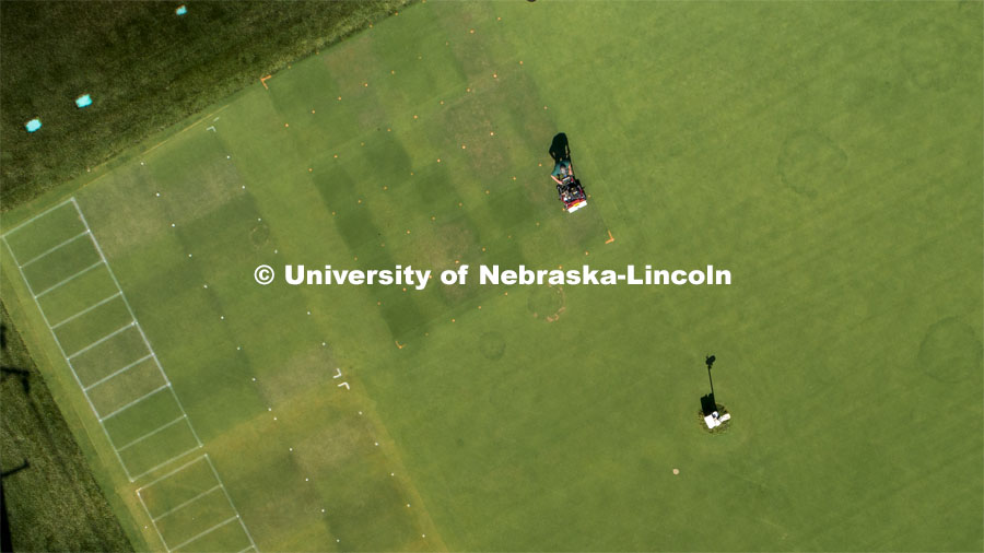 Craig Ferguson, ag research technician, cuts the grass on the turf grass test plots on east campus. He was collecting the clippings to analyze treatment data. Turf Grass test plots on East Campus. July 22, 2020. Photo by Craig Chandler / University Communication.