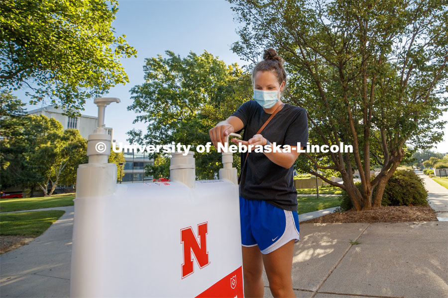 Maggie Ferguson, a May 2020 College of Business graduate, tries out a hand sanitizer station outside Westbrook Music Building. It is one of the more than 1,500 new hand sanitizer stations being distributed around the three UNL campuses. July 28, 2020. Photo by Craig Chandler / University Communication.
