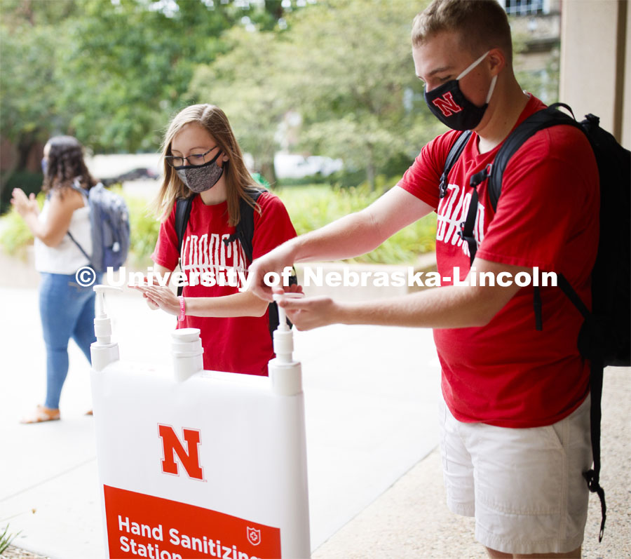 Photo shoot of students display mask wearing and hand sanitizing. Students at a hand sanitizing station stop to clean their hands. August 5, 2020. Photo by Craig Chandler / University Communication.