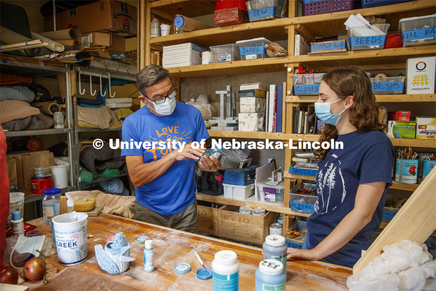 Eddie Dominguez, Professor of Art, works with Kinga Aletto. Aletto, a junior in College of Agriculture Sciences and Natural Resources, works on a life-size clay model of the Javan blue-banded kingfisher. Her UCARE research project includes making a life size Javan Blue-banded king out of clay. The reason why this bird was chosen was because it is critically endangered and receives little to no coverage on this fact. Through learning new clay building skills, she is able to bring this bird to life in Nebraska and bring awareness to its' struggles. August 7, 2020. Photo by Craig Chandler / University Communication.