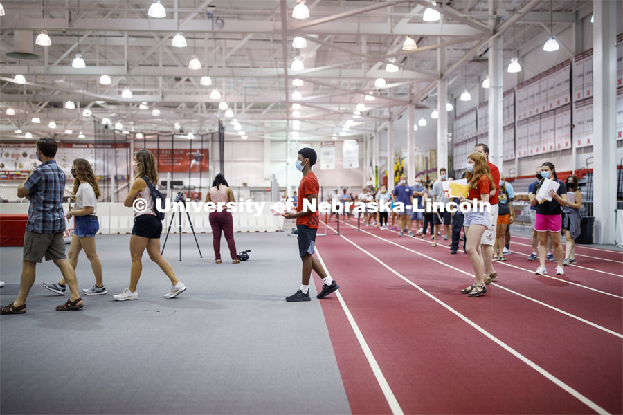 Students social distance as they work their way around the track in Devaney Sports Center to complete their paperwork and obtain their check in information. First day of residence hall move in. August 13, 2020. Photo by Craig Chandler / University Communication.