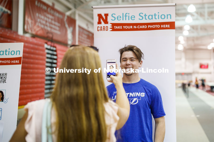 Ryan Lawton of Tampa Bay Florida has his photo taken by his mom for his N Card. Devaney Sports Center check in. First day of residence hall move in. August 13, 2020 Photo by Craig Chandler / University Communication