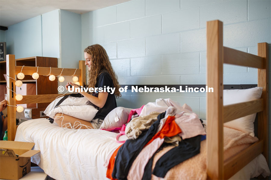 Breeana Read of Omaha plugs her phone charger in as she decorates her room. First day of residence hall move in. August 13, 2020. Photo by Craig Chandler / University Communication.