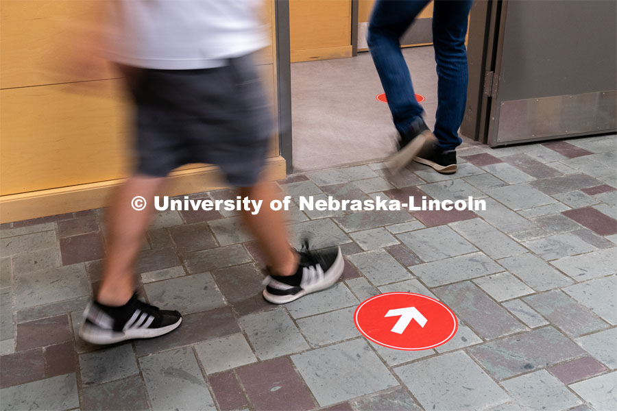 Directional floor arrows keep students at a safe distance. Students walk through the hallways inside of Andersen Hall to get to class during the first day of in-person instruction at the University of Nebraska-Lincoln on Monday, August 24, 2020. Photo by Jordan Opp for University Communication.