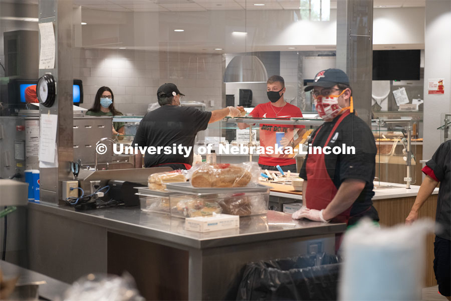 Kitchen staff prepare and give out meals in the newly renovated Dinning Center in the East Campus Union. First day of in-person learning for the fall semester. August 24, 2020. Photo by Gregory Nathan / University Communication.