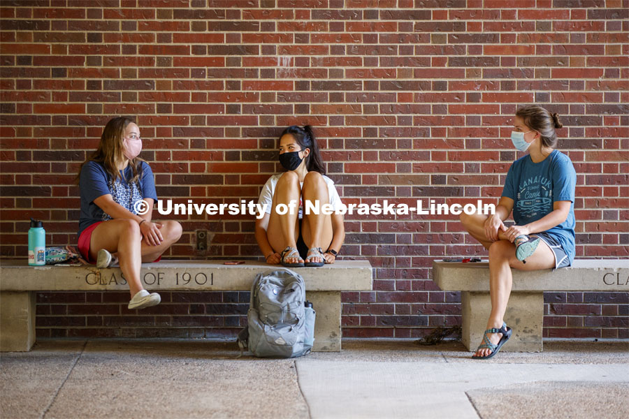 Nikki Gotschall, Katie Patton and Lillian Lambrechts enjoy each other's company and the afternoon shade outside Love Library. First day for in-person learning for the fall semester.  August 24, 2020. Photo by Craig Chandler / University Communication.