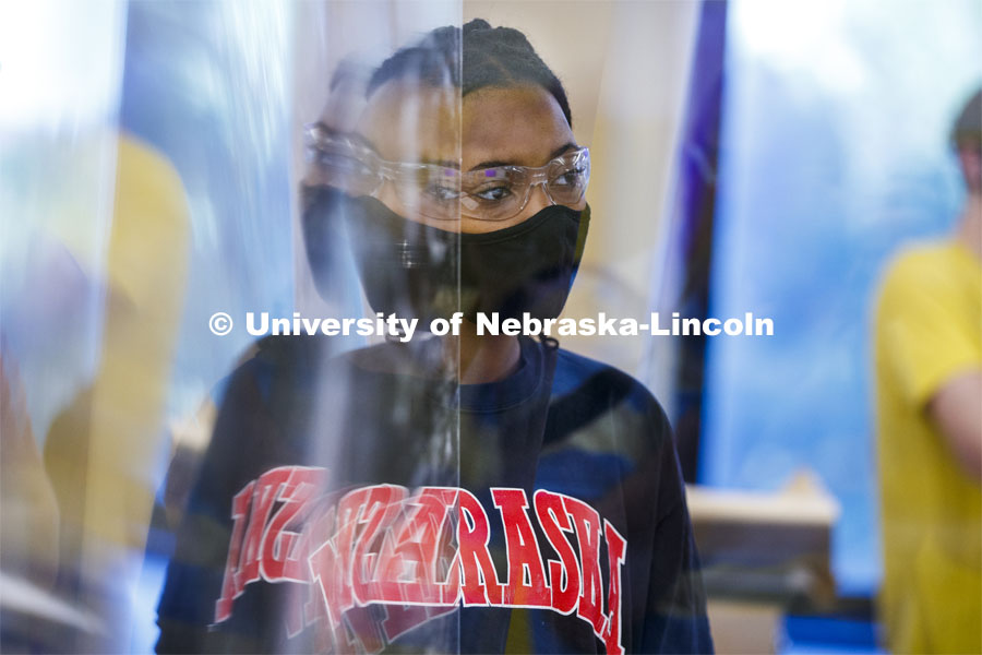 Kyra Baptiste of Topeka, KS, is reflected in an acrylic divider in her Chemistry 105 lab. First day for in-person learning for the fall semester. August 24, 2020. Photo by Craig Chandler / University Communication.
