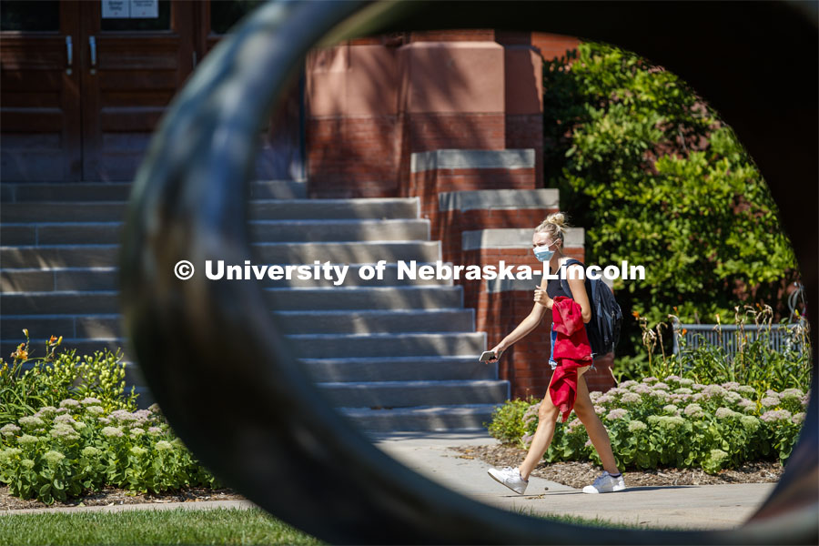 Erin Brandvik, freshman from Woodbury, MN, is framed by the Fragment X-O sculpture in the Sheldon Sculpture Garden. City Campus. August 26, 2020. Photo by Craig Chandler / University Communication.