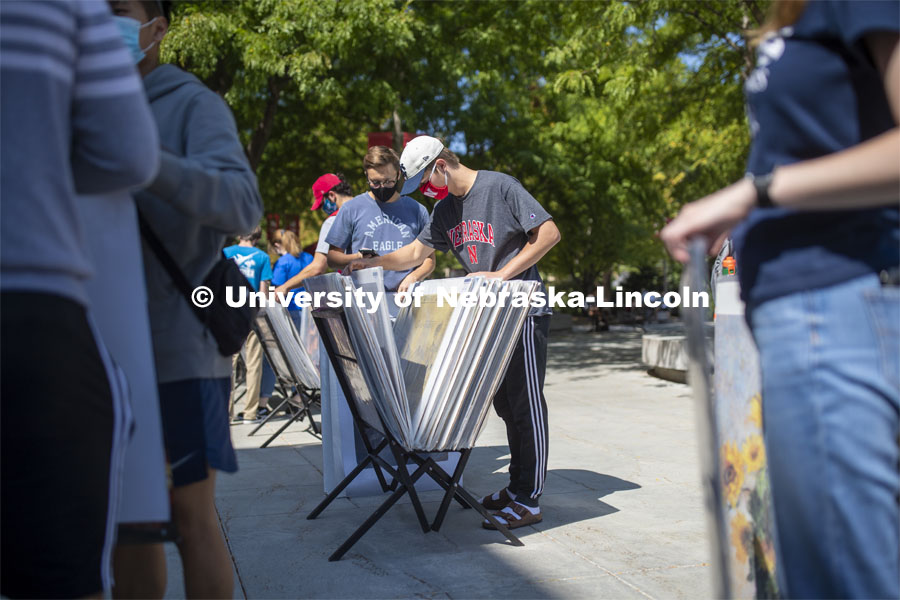 Jack Van Nieuwenhuyse and his Knoll Residence Hall roommate Easton Sckerl look over posters for sale in front of the Nebraska Union Monday. City Campus. August 31, 2020. Photo by Craig Chandler / University Communication.