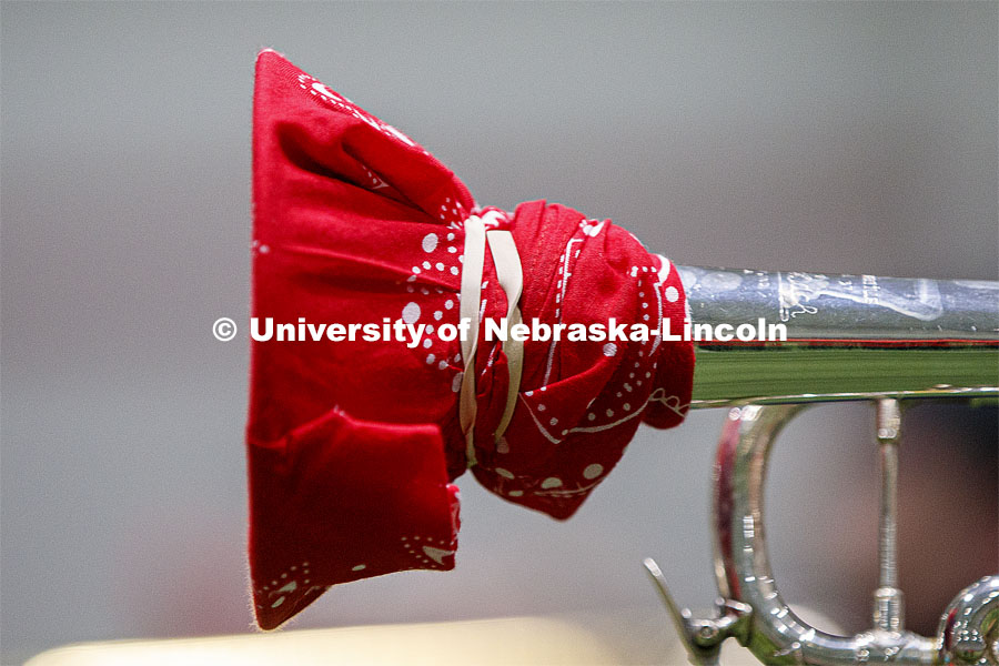 Band members have used ingenuity to cover their horn's bell. Cornhusker Marching Band practice in Cook Pavilion. September 10, 2020. Photo by Craig Chandler / University Communication.