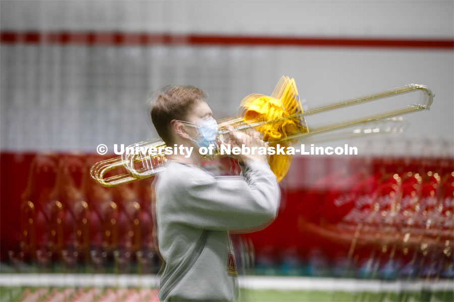 Hayden Fuelberth marches in the multiple exposure image. Cornhusker Marching Band practice in Cook Pavilion. September 10, 2020. Photo by Craig Chandler / University Communication.