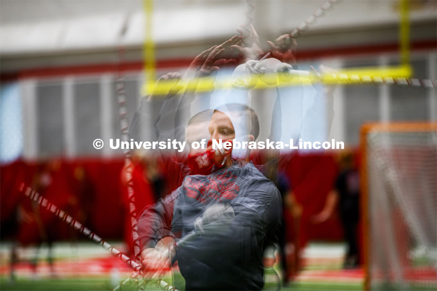 Drum Major Jacob Coughlin practices his mace twirl in a multiple exposure image. One third of the marching band meets each morning at Cook to practice as the rest of the band practices in other locations where they can properly distance. Cornhusker Marching Band practice in Cook Pavilion. September 10, 2020. Photo by Craig Chandler / University Communication.