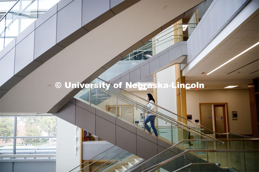 A young woman walking up the stairs in Hawks Hall. September 14, 2020. Photo by Craig Chandler / University Communication.