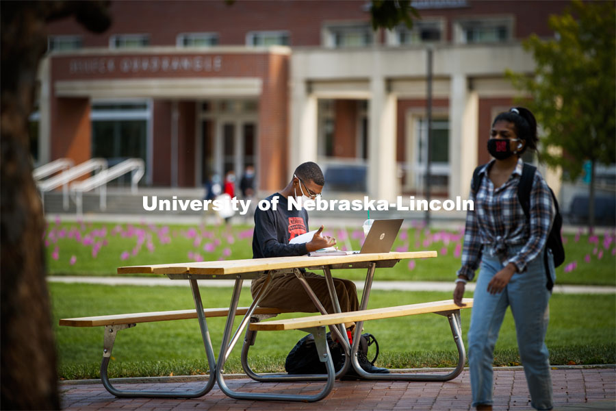 Seth Caines works on his chemistry homework on the greenspace outside the Nebraska Union. City Campus. October 5, 2020. Photo by Craig Chandler / University Communication.
