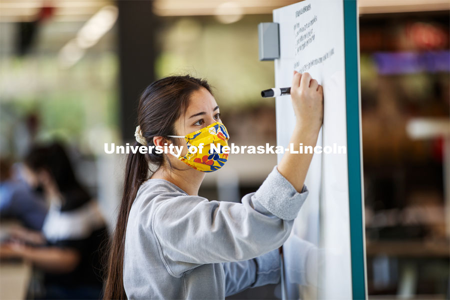 Madison Han, senior in Nutritional Science and Dietetics, uses a white marker board in the Adele Coryell Hall Learning Commons to work on her anatomy homework. City Campus. October 5, 2020. Photo by Craig Chandler / University Communication.