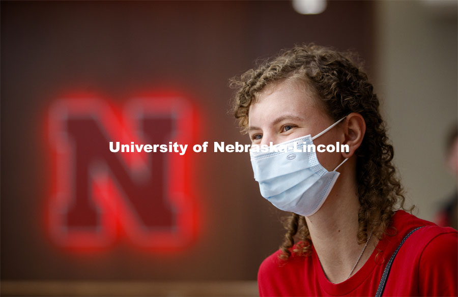 A young woman sits in front of a Nebraska N inside the remodeled Nebraska East Union. East Campus photo shoot. October 13, 2020. Photo by Craig Chandler / University Communication.