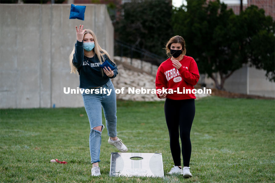 Representatives of Alpha Omicron Pi and Chi Omega alternate tossing beanbags during the ASUN Cornhole Competition at the Cather-Pound Greenspace on Wednesday, October 28, 2020, in Lincoln, Nebraska. Photo by Jordan Opp for University Communication.