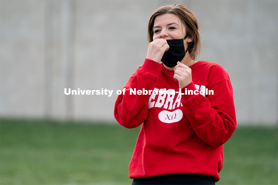 Chi Omega’s Sadie Lamplot laughs after a throw during the ASUN Cornhole Competition at the Cather-Pound Greenspace on Wednesday, October 28, 2020, in Lincoln, Nebraska. Photo by Jordan Opp for University Communication.