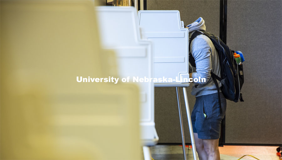 Hunter Parker, from Los Angeles, ponders the ballot as he votes in his first presidential election. Voting in the Nebraska Union for the 2020 Presidential Election. November 3, 2020. Photo by Craig Chandler / University Communication.