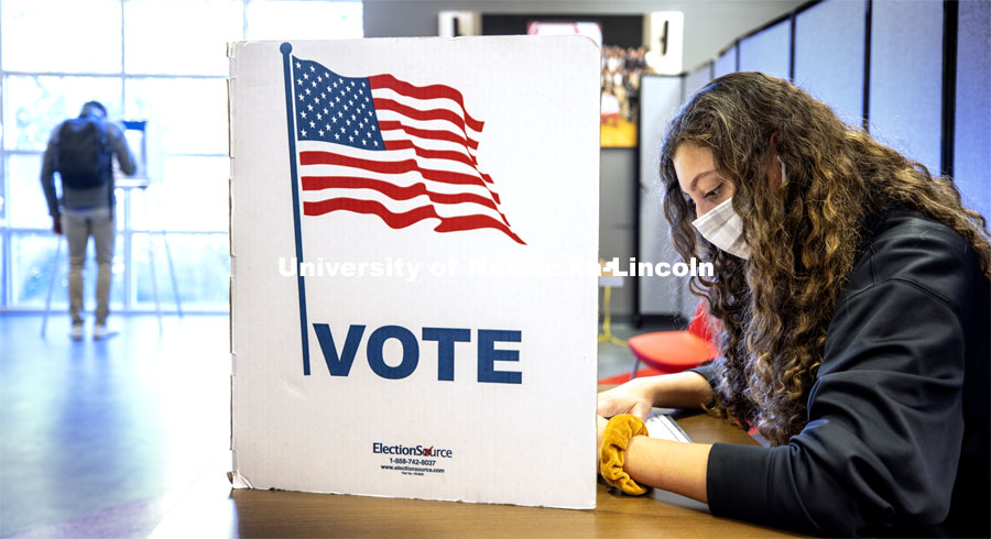 Grace Carey, a freshman from Bellevue, Nebraska, votes in her first election. Voting in the Nebraska Union for the 2020 Presidential Election. November 3, 2020. Photo by Craig Chandler / University Communication.