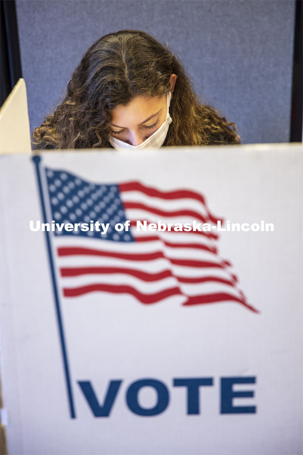 Grace Carey, a freshman from Bellevue, Nebraska, votes in her first election. Voting in the Nebraska Union for the 2020 Presidential Election. November 3, 2020. Photo by Craig Chandler / University Communication.