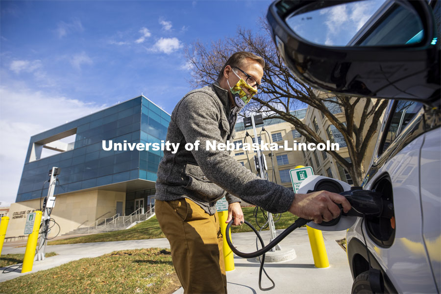 Dan Carpenter, Director of Parking and Transit Services, plugs in a Chevy Bolt to charge at the new charging station in front of Howard Hawks Hall. There are four new charging stations on the UNL campuses. The stations are capable of charging Teslas, along with other popular brands of electric vehicles. November 12, 2020.  Photo by Craig Chandler / University Communication.
