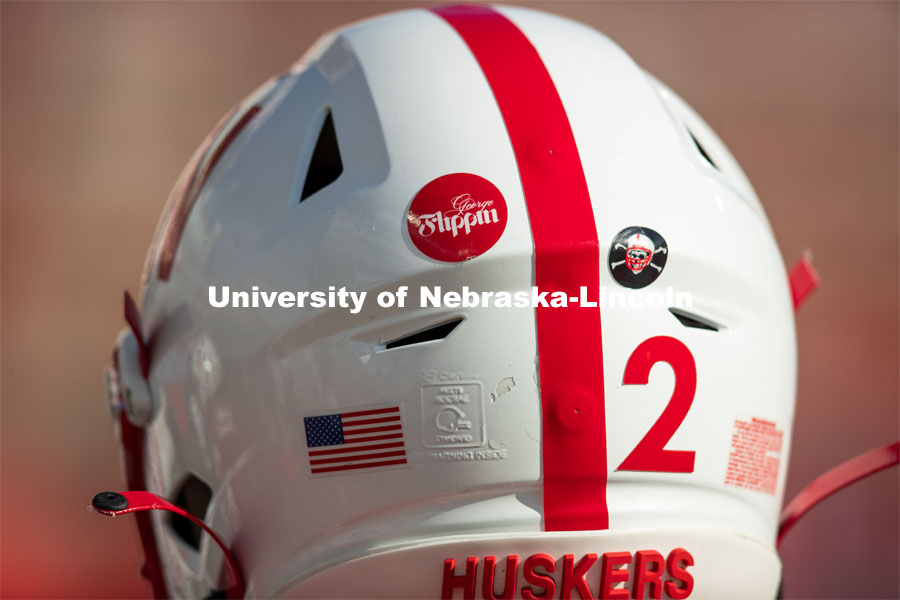 Helmet stickers honor George Flippin. George Flippin attended the University of Nebraska from 1891 to 1894. He was the first African-American football player for the University. Missouri refused to play a scheduled football game, forfeiting 1-0 because of Flippin’s presence on the team. He was inducted into the Nebraska Football Hall of Fame in 1974. Team Huddle. Football vs Penn State. November 14, 2020. Photo by Scott Bruhn / Husker Athletics