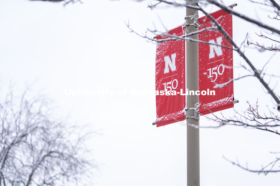 An N 150 Banner is covered in snow. Snow on UNL City Campus. December 12, 2020. Photo by Jordan Opp for University Communication.