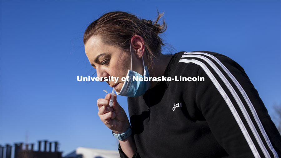 Jessica Calvi, a research assistant professor with the Nebraska Athletic Performance Lab, demonstrates the new saliva-based COVID test for all students, faculty and staff on campus. January 4, 2021. Photo by Craig Chandler / University Communication.